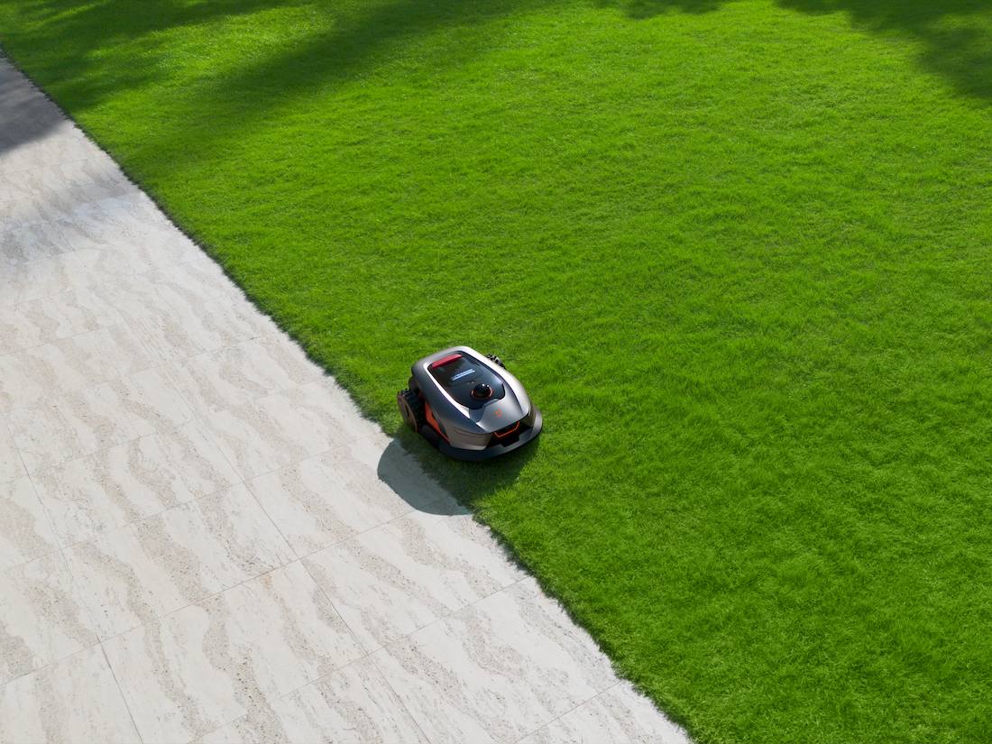 Robotic Lawn Mower On Green Grass
