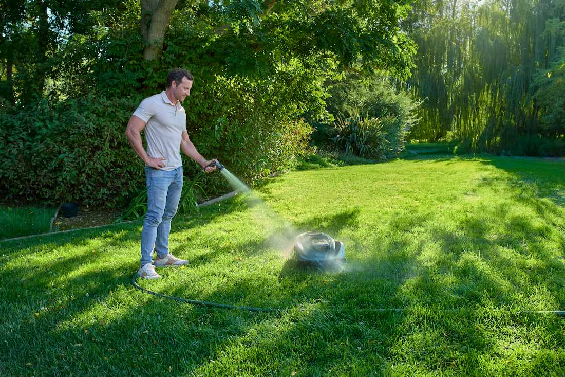 man watering lawn grass
