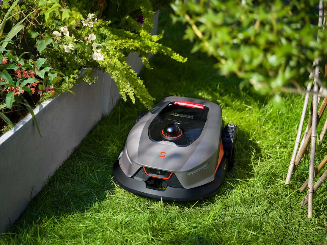 robotic mower cutting grass before overseeding a lawn