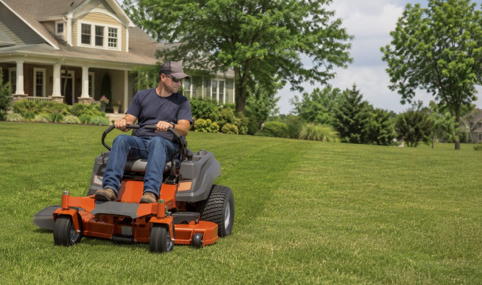 Zero-turn mower with lap bars and front caster wheels turning around a tree